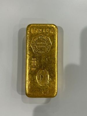 two gold bars sitting side by side on a white surface