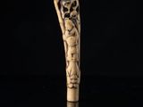 an old carved cane with a skeleton head on it
