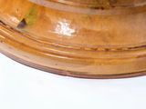 a wooden bowl with a lid on a white surface