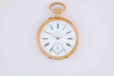 a gold pocket watch with roman numerals on the face