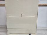 a white cabinet with a door and some screws on it