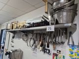 many pots and pans hanging on the wall