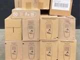boxes stacked on top of each other on a pallet in front of a black wall