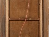 an old wooden frame with a red string attached to it