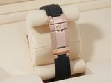 a black and rose gold watch in a white box