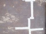 a white cross painted on the side of a building