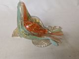 a glass bird that is sitting on a table