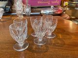 four wine glasses sitting on a table in a room