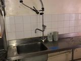 a kitchen with a sink and a faucet in it