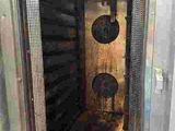 a metal door that is open with a clock on it