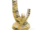 a yellow and white vase with a black and white design on it