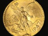 a close up of a gold coin with an angel on it