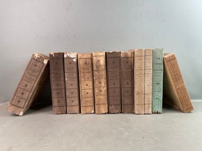 several old books are stacked on top of each other on a table