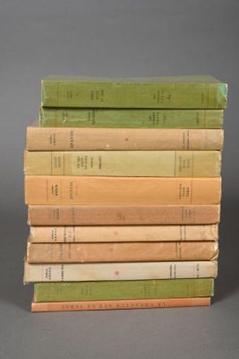 several books stacked on top of each other on a gray surface
