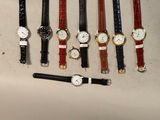 plusieurs montres et un stylo posés sur une table