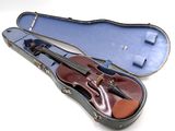 a violin in a case on a white surface