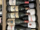 bottles of wine are in a cardboard box on a table