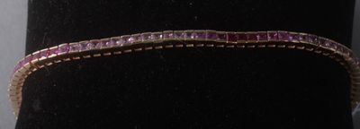 bracelet violet et doré présenté sur un mannequin noir
