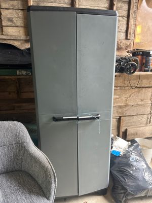 a refrigerator and a chair in a room next to a chair