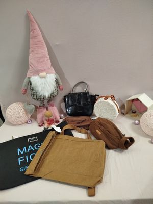 a table with many items on it including a book, a bag, and a gnome