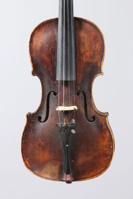 an old violin with a bow hanging from it ' s back