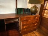 a wooden desk with a lamp on top of it