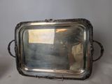 a silver tray with a mirror on it on a table