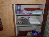 a closet with a lot of clothes and a tie