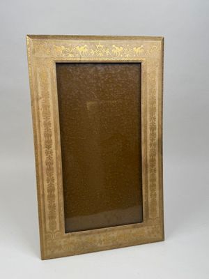 an old picture frame sitting on a white surface with a white background