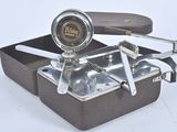 a small metal box with a handle and a handle on it