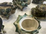 many different types of teapots and cups on the table