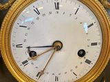 a gold and black clock with a lion on it
