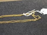 a gold chain with a tag attached to it