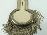 a small metal object with a fringe around it