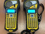 two yellow and black walkie talkies sitting on top of a wooden table
