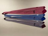 four ties are arranged in a row on a white surface