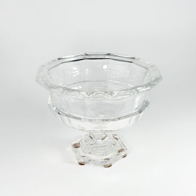 a clear glass bowl sitting on top of a wooden stand