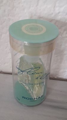 a glass jar with ice in it sitting on a table