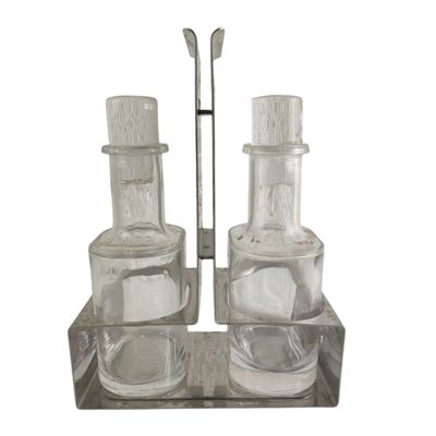 bottles and spoons are sitting on a wooden tray on a white background