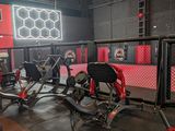 gym equipment in a gym with red walls and black flooring
