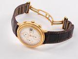 an image of a gold watch with a brown leather strap