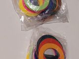 two rolls of colored tape in a bag on a table