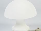 a close up of a white mushroom shaped lamp on a white surface
