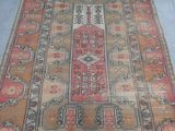 rug on the floor with a cat sitting on top of it