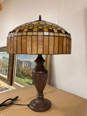 a lamp that is sitting on a table next to a picture