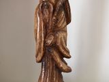 a statue of a man with a bird on his shoulder