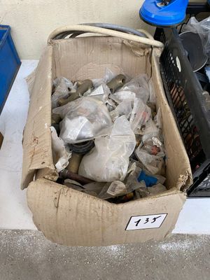 a cardboard box full of trash sitting on the ground