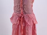 pink dress on a mannequin stand with a white background