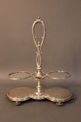 a silver plate with a handle on it on a table