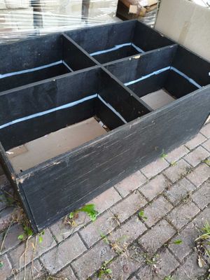 a black wooden box that is sitting on the ground